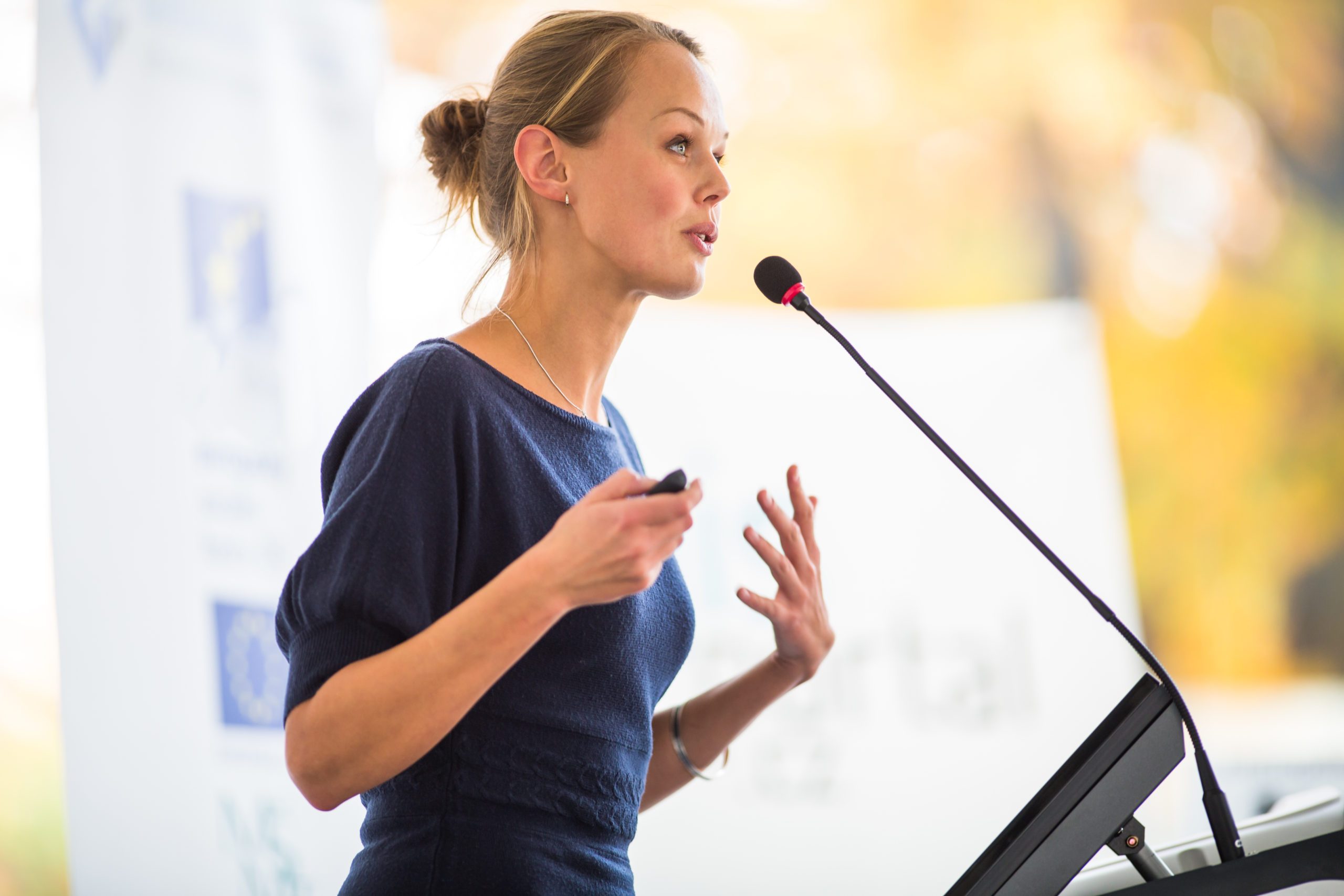Pretty,,Young,Business,Woman,Giving,A,Presentation,In,A,Conference/meeting
